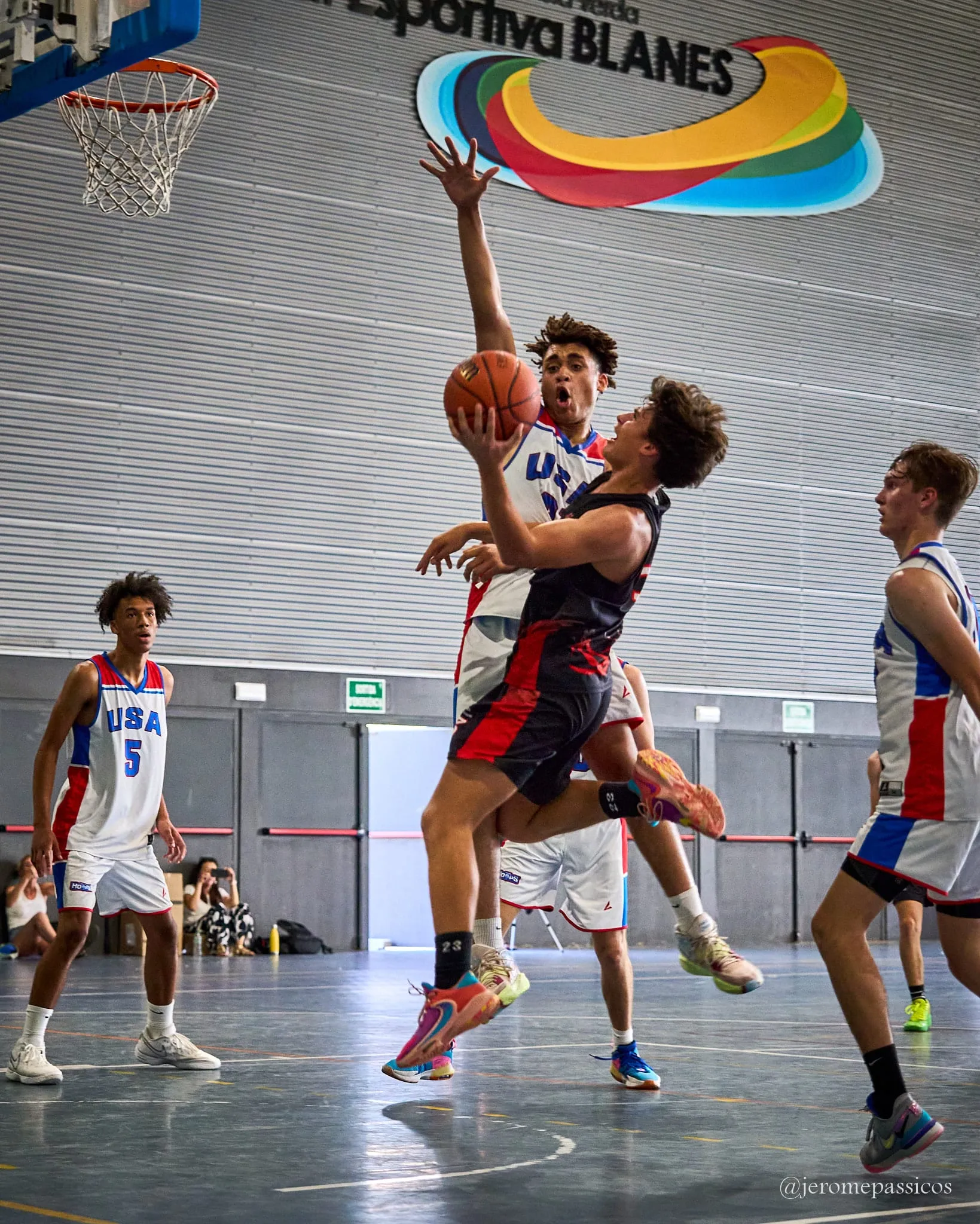 A player laying the ball up under the basket at the Blanes sports centre