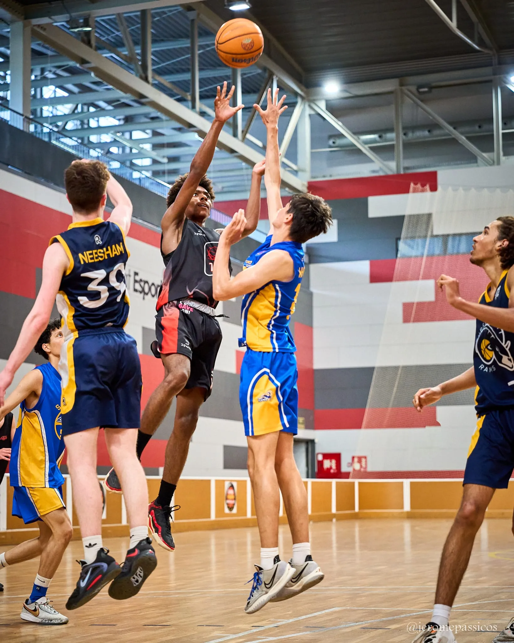 Three players going up together for the same rebound