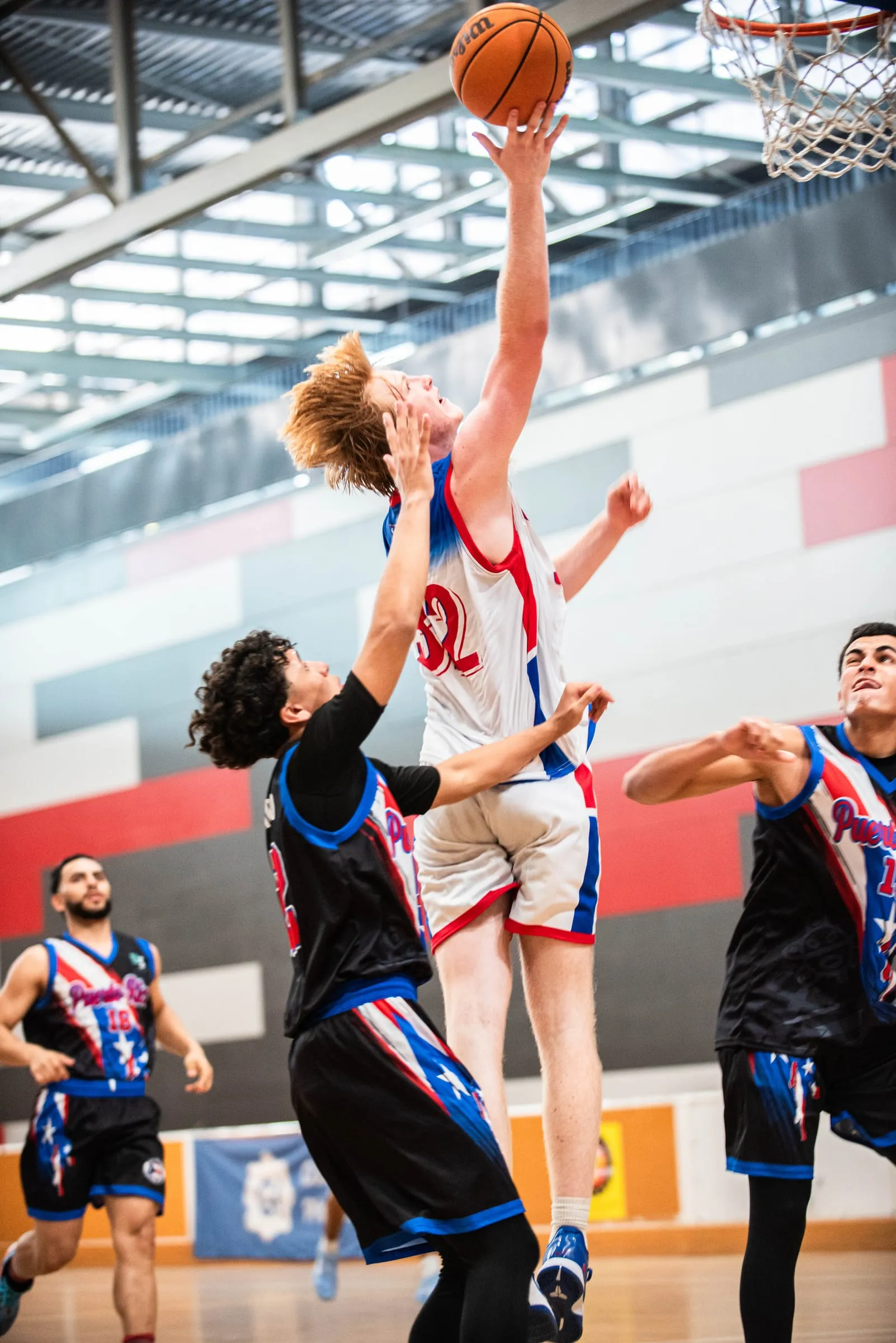 A player leaping to the rim with the ball above his head
