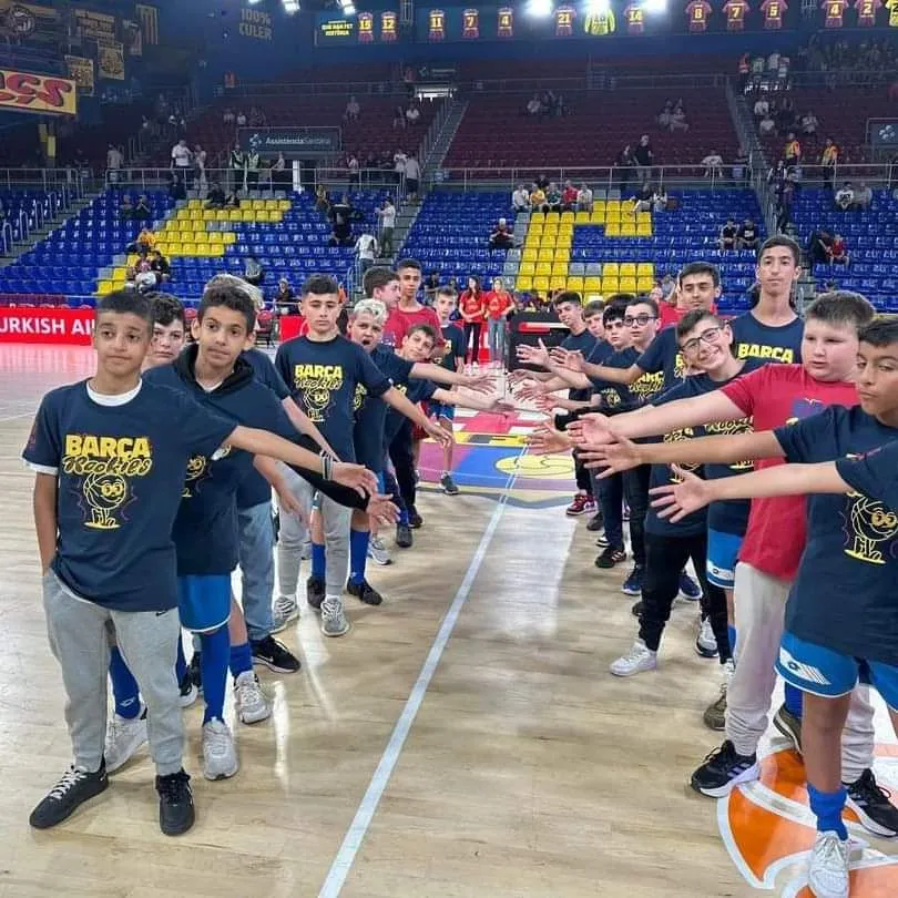Two teams walking out along the court, high-fiving as they pass