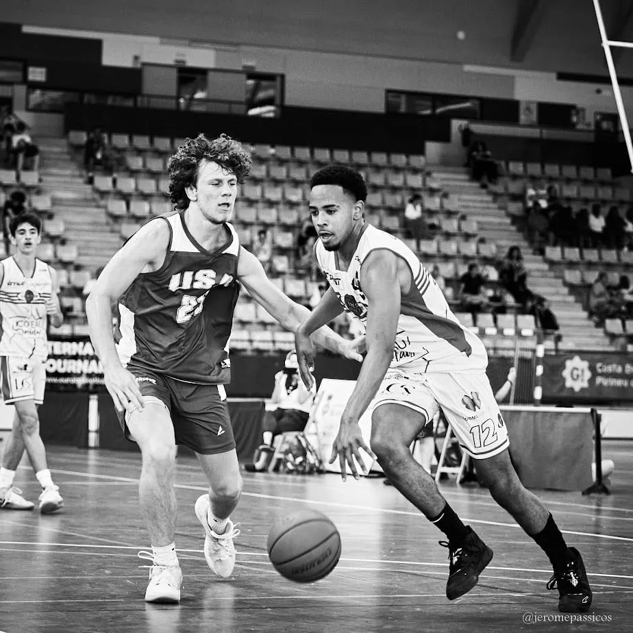 Two players chasing a loose ball down the court