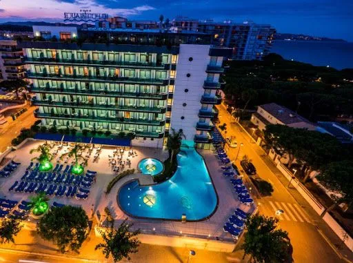 The pool at one of the four-star hotels, lit at night